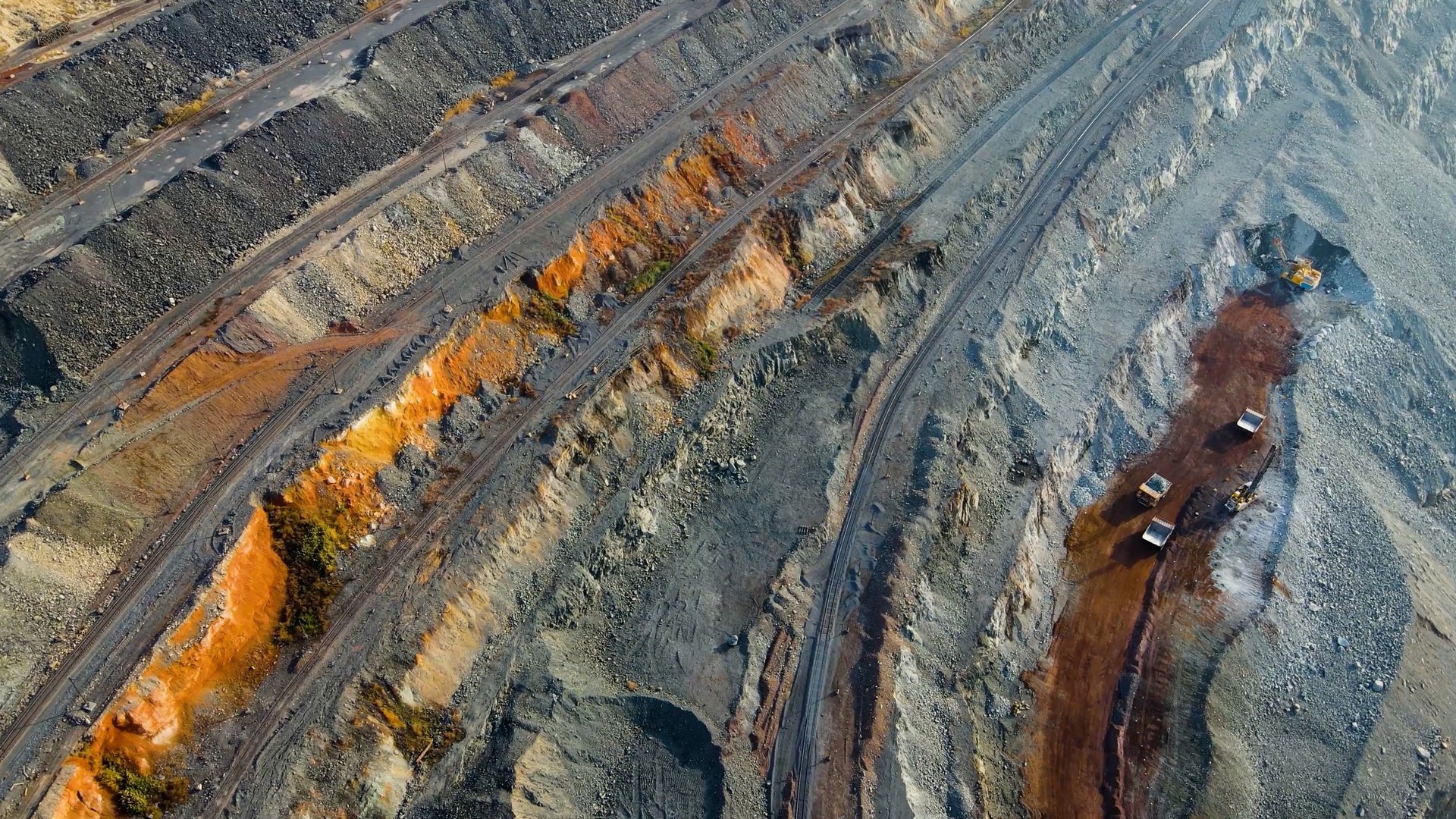 Aerial view of an iron ore quarry and mining site showing terraced extraction benches