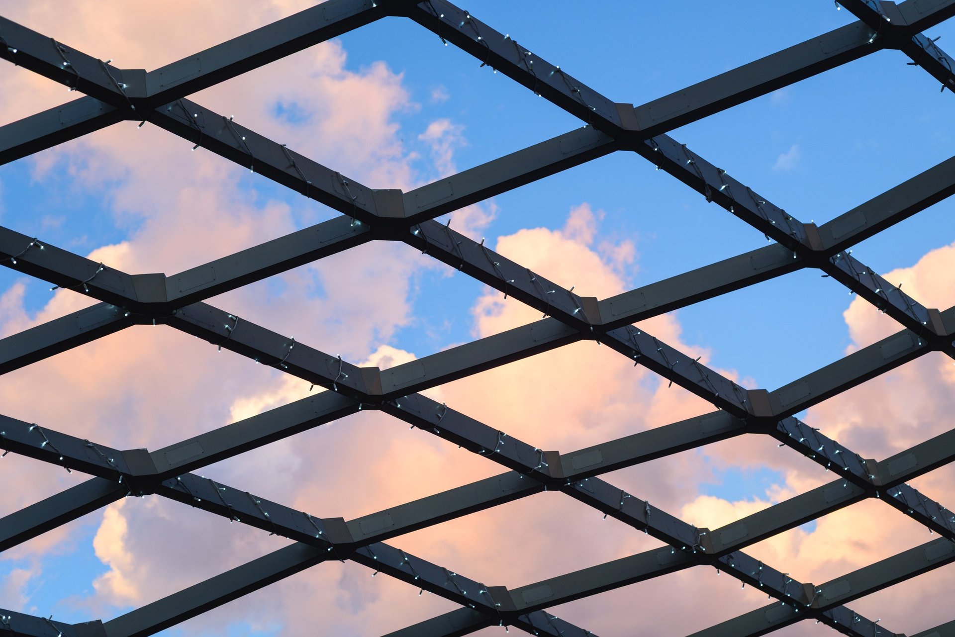 Dense steel lattice truss grid viewed from below