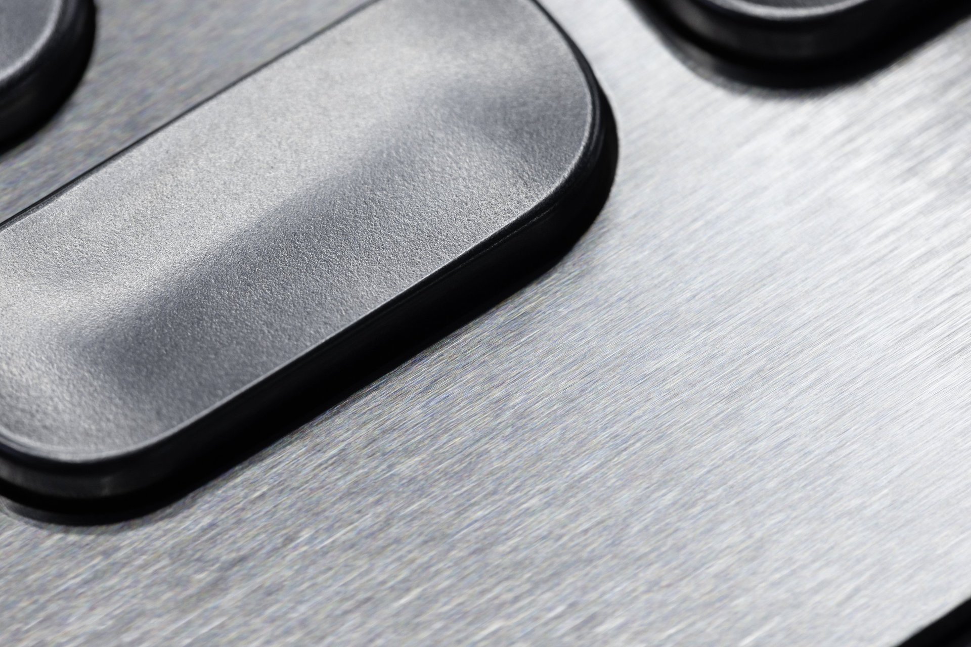 Close view of a brushed stainless steel appliance control panel with a fine brushed surface