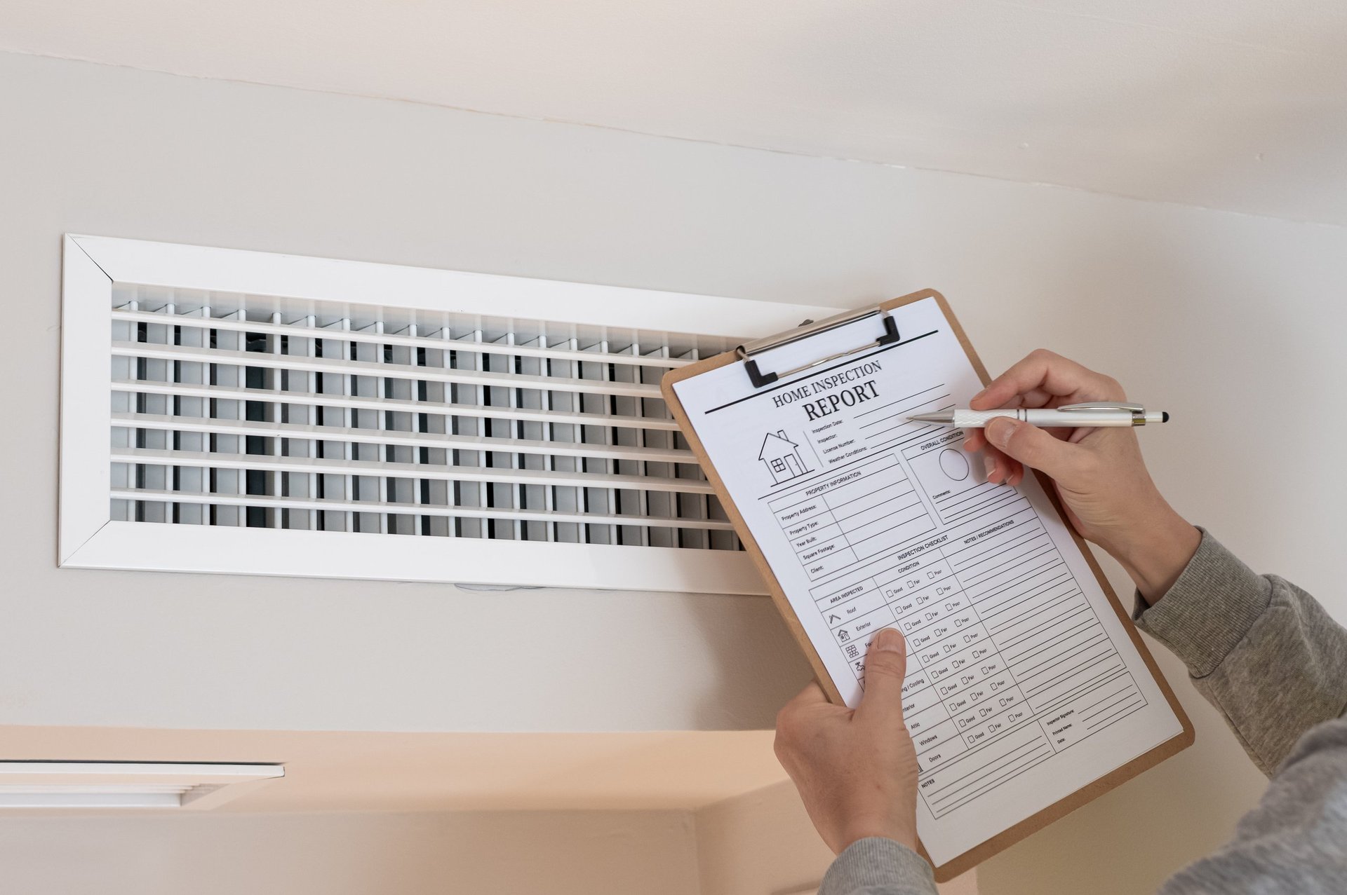 Inspector recording findings on a report form during a technical assessment