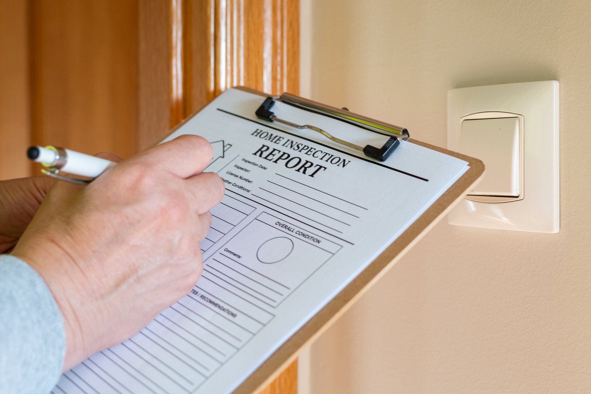 Inspector completing a report form against documented requirements