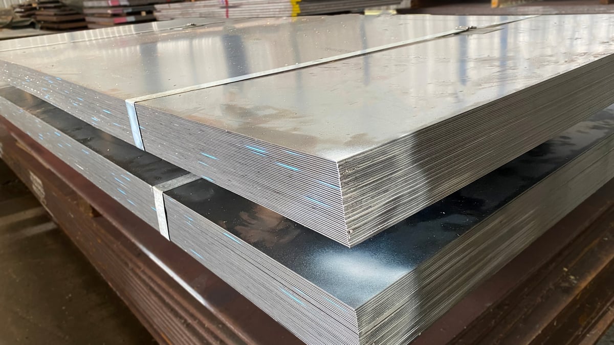 Stacked steel sheets identified by material family in a warehouse before selection