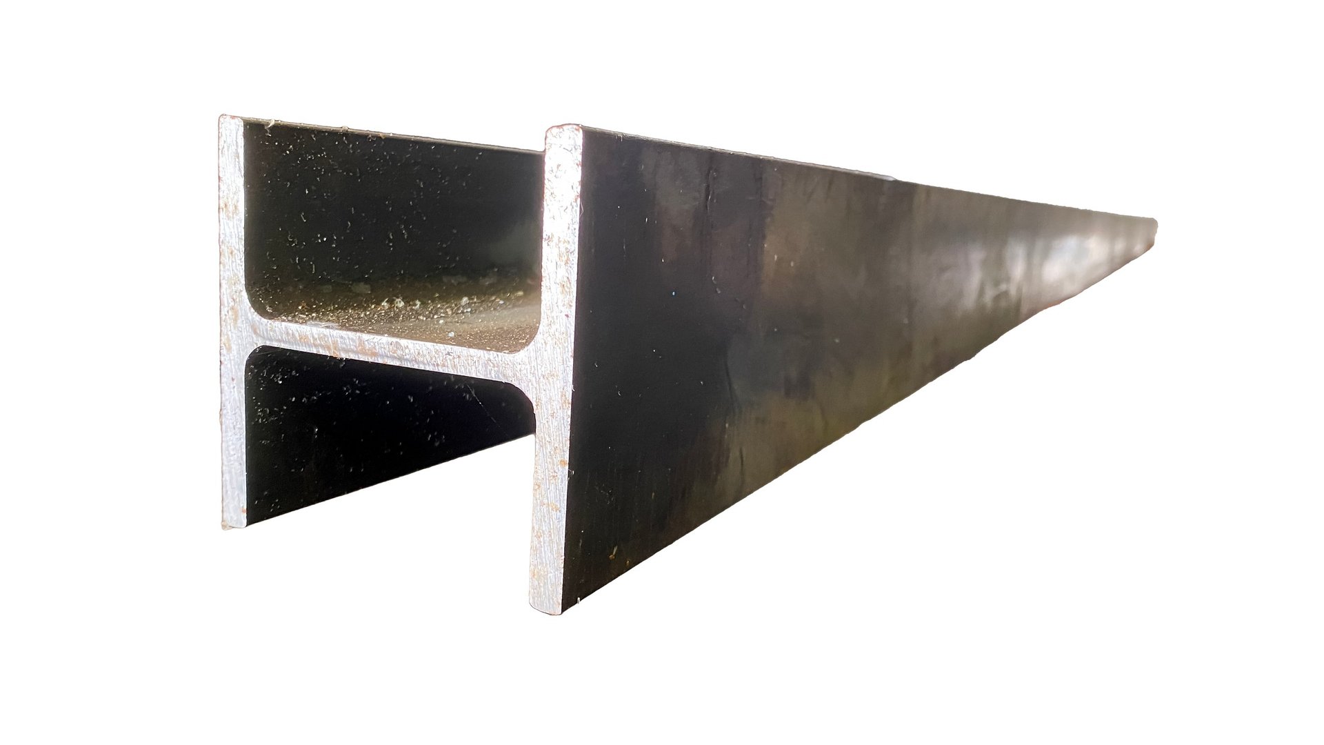 Stacked steel sections stored for industrial frame fabrication