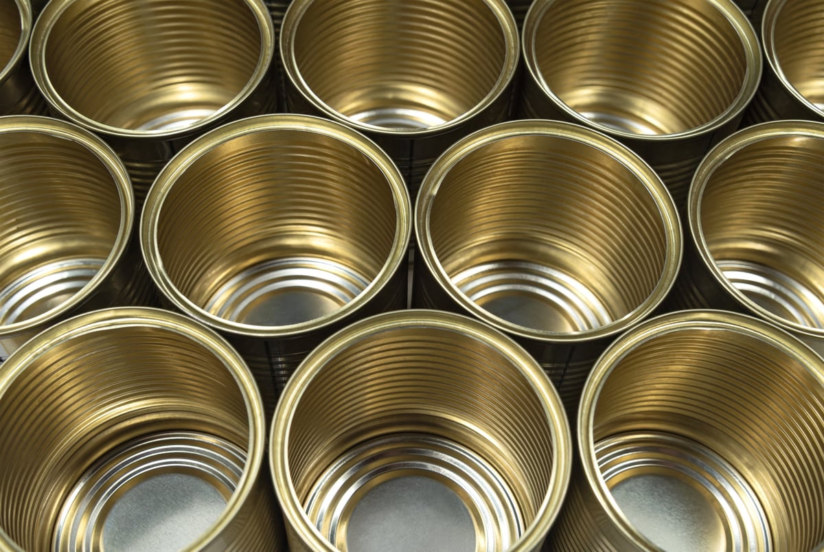 Empty tin cans without lids ready for filling on a packaging line