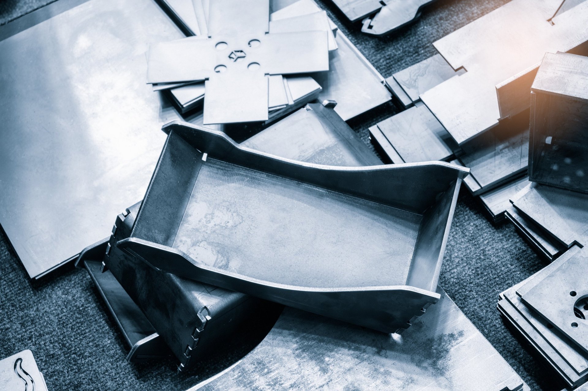 Formed steel sheet samples laid out for surface and profile inspection before dimensional verification