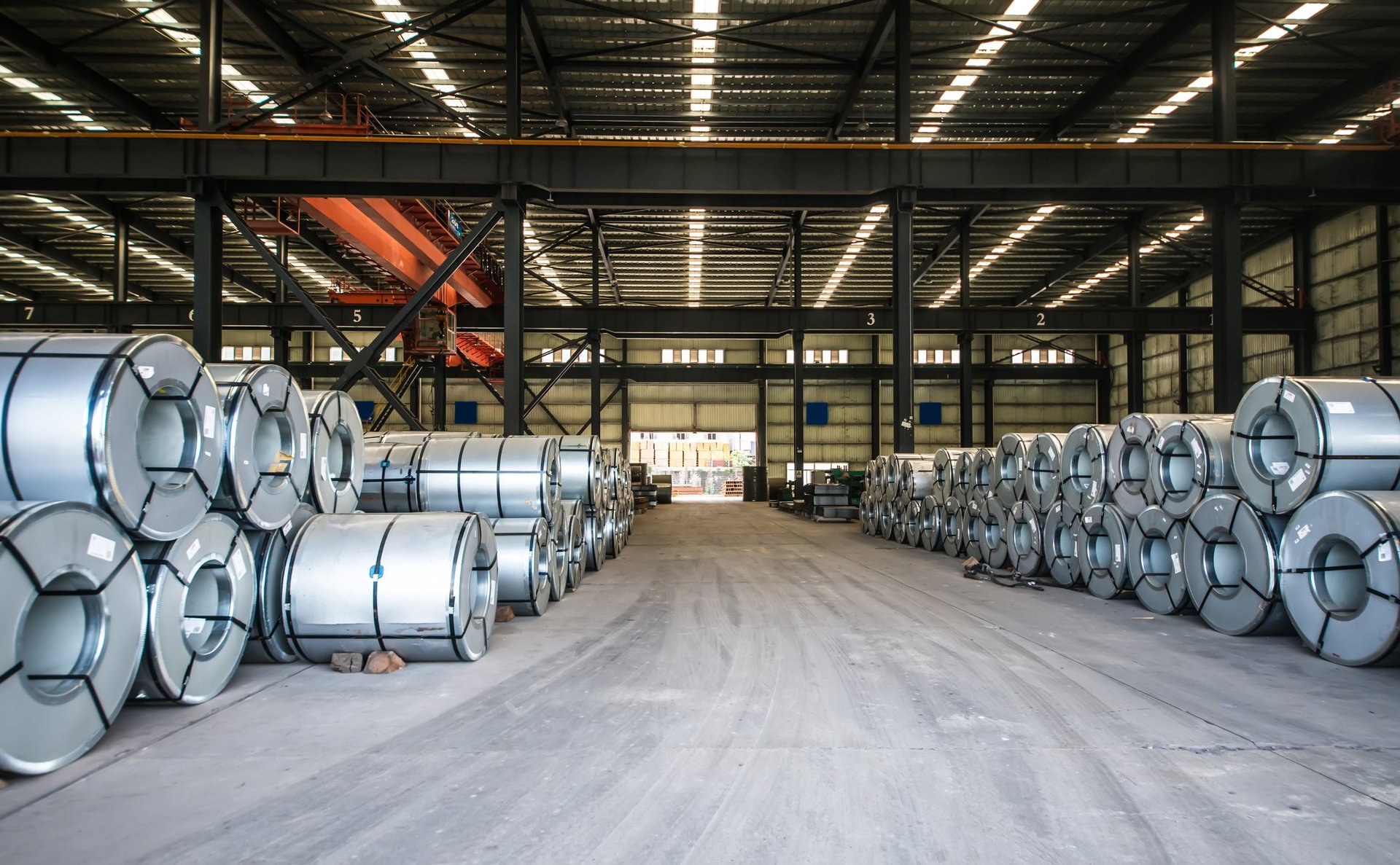 Coiled and flat steel sheet stacked ready for cutting and despatch
