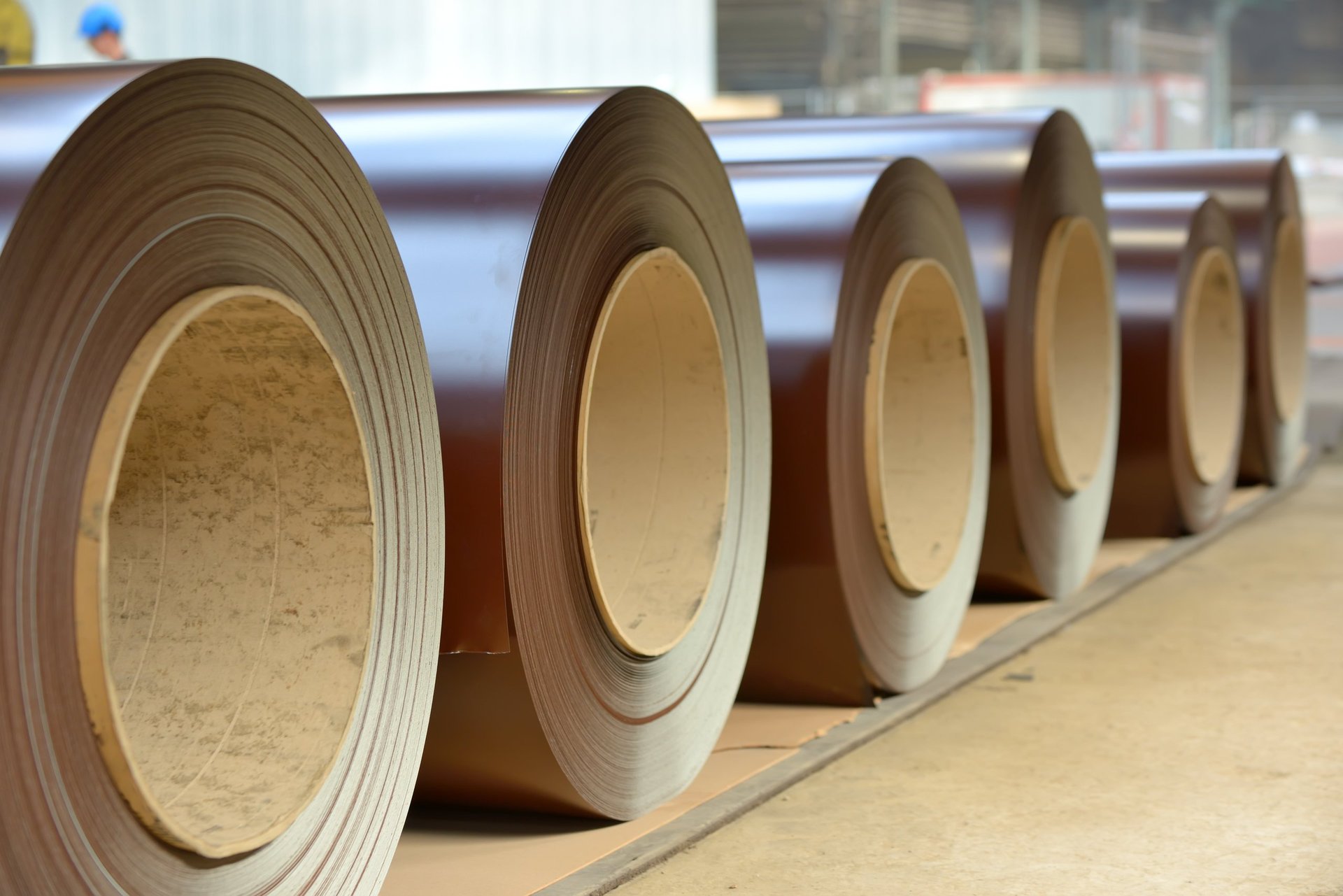 Pre-painted galvanized steel coils stacked in a warehouse