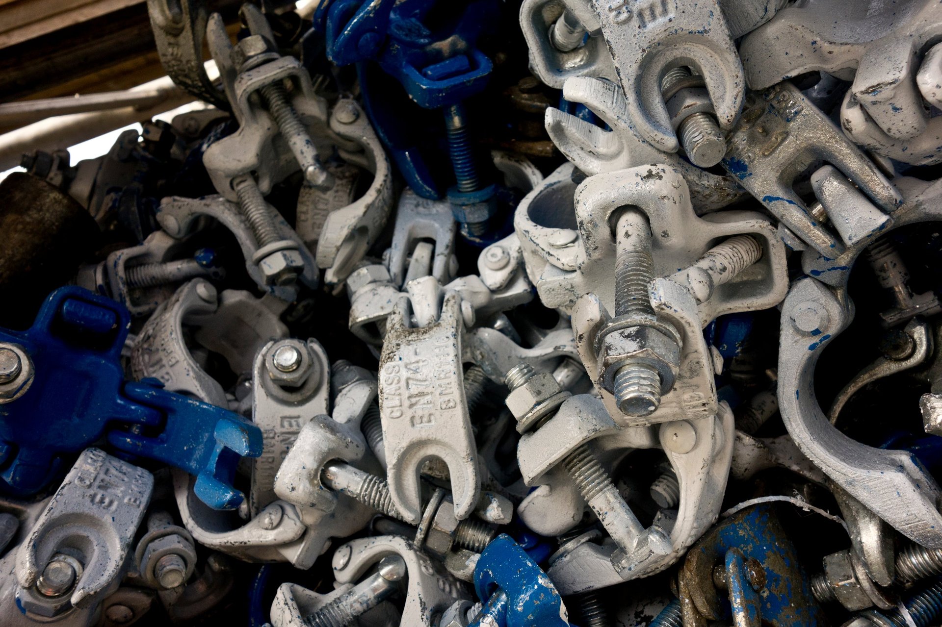 Galvanized scaffolding pipe — scaffold coupler and tube interface detail showing the clamped connection.